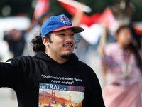 Members of the Muwekma Ohlone Tribe of the San Francisco Bay Area, along with other tribal groups and their supporters, cross the Arlington...