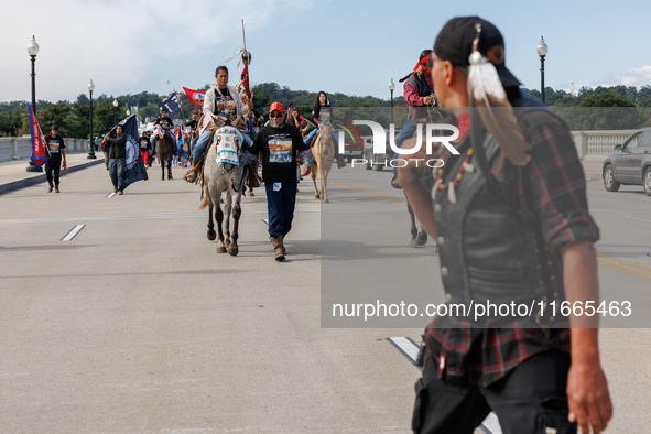 Members of the Muwekma Ohlone Tribe of the San Francisco Bay Area, along with other tribal groups and their supporters, cross the Arlington...