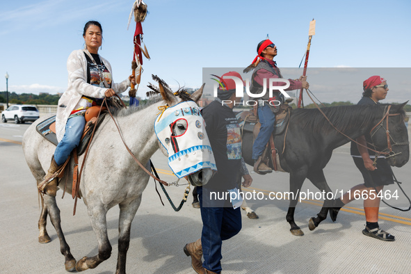 Members of the Muwekma Ohlone Tribe of the San Francisco Bay Area, along with other tribal groups and their supporters, cross the Arlington...