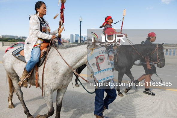 Members of the Muwekma Ohlone Tribe of the San Francisco Bay Area, along with other tribal groups and their supporters, cross the Arlington...