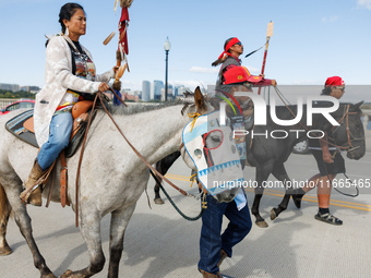 Members of the Muwekma Ohlone Tribe of the San Francisco Bay Area, along with other tribal groups and their supporters, cross the Arlington...