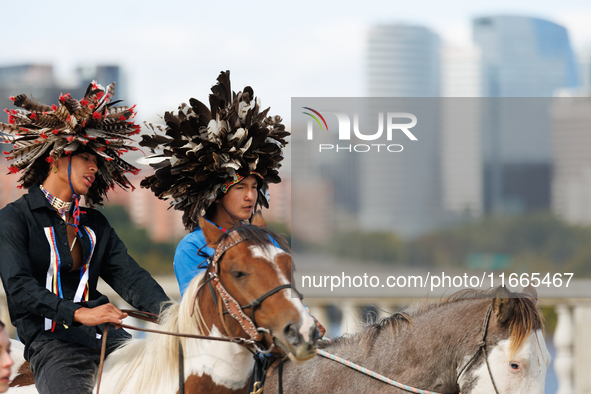 Members of the Muwekma Ohlone Tribe of the San Francisco Bay Area, along with other tribal groups and their supporters, cross the Arlington...