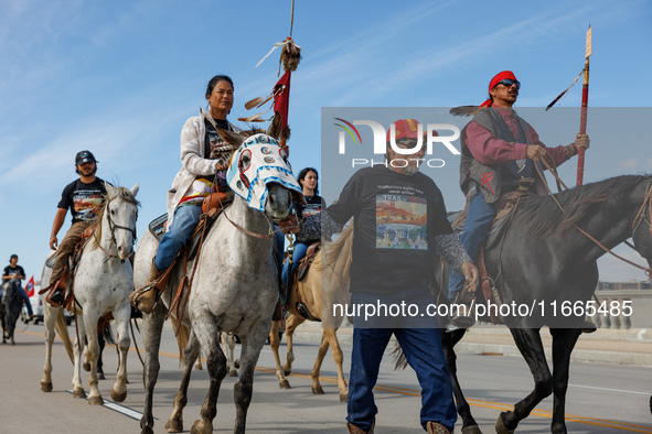 Members of the Muwekma Ohlone Tribe of the San Francisco Bay Area, along with other tribal groups and their supporters, cross the Arlington...