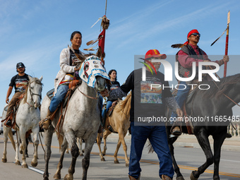 Members of the Muwekma Ohlone Tribe of the San Francisco Bay Area, along with other tribal groups and their supporters, cross the Arlington...