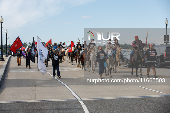 Members of the Muwekma Ohlone Tribe of the San Francisco Bay Area, along with other tribal groups and their supporters, cross the Arlington...