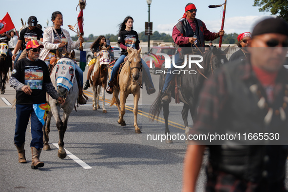 Members of the Muwekma Ohlone Tribe of the San Francisco Bay Area, along with other tribal groups and their supporters, cross the Arlington...