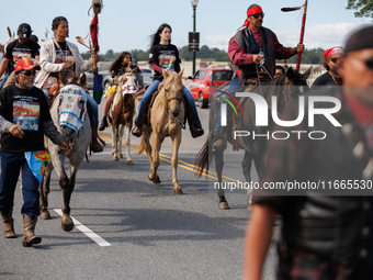 Members of the Muwekma Ohlone Tribe of the San Francisco Bay Area, along with other tribal groups and their supporters, cross the Arlington...