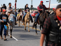 Members of the Muwekma Ohlone Tribe of the San Francisco Bay Area, along with other tribal groups and their supporters, cross the Arlington...