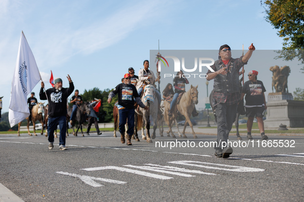 Members of the Muwekma Ohlone Tribe of the San Francisco Bay Area, along with other tribal groups and their supporters, cross the Arlington...