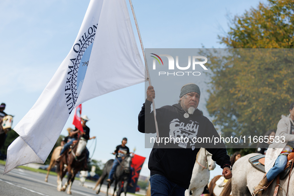 Members of the Muwekma Ohlone Tribe of the San Francisco Bay Area, along with other tribal groups and their supporters, cross the Arlington...