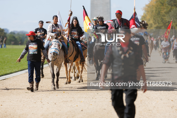 Members of the Muwekma Ohlone Tribe of the San Francisco Bay Area, along with other tribal groups and their supporters, march along the Nati...