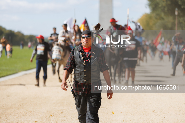 Members of the Muwekma Ohlone Tribe of the San Francisco Bay Area, along with other tribal groups and their supporters, march along the Nati...