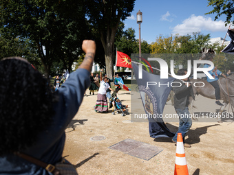 Members of the Muwekma Ohlone Tribe of the San Francisco Bay Area, along with other tribal groups and their supporters, march along the Nati...