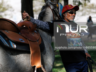 Members of the Muwekma Ohlone Tribe of the San Francisco Bay Area, along with other tribal groups and their supporters, arrive on horseback...