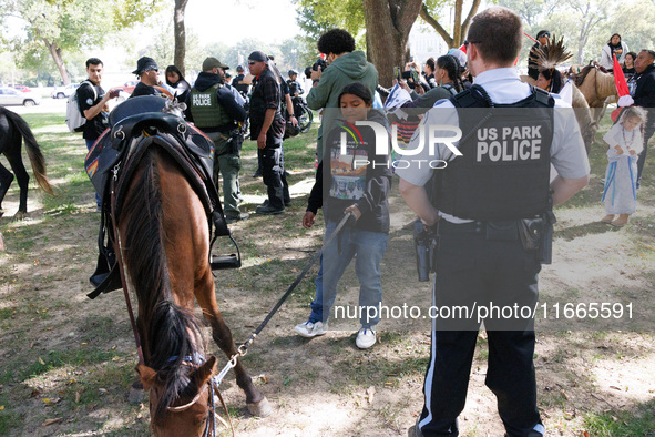 U.S. Park Police officers speak with members of the Muwekma Ohlone Tribe of the San Francisco Bay Area, after the group arrived on horseback...