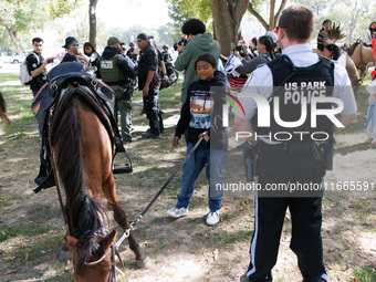 U.S. Park Police officers speak with members of the Muwekma Ohlone Tribe of the San Francisco Bay Area, after the group arrived on horseback...