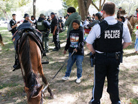 U.S. Park Police officers speak with members of the Muwekma Ohlone Tribe of the San Francisco Bay Area, after the group arrived on horseback...