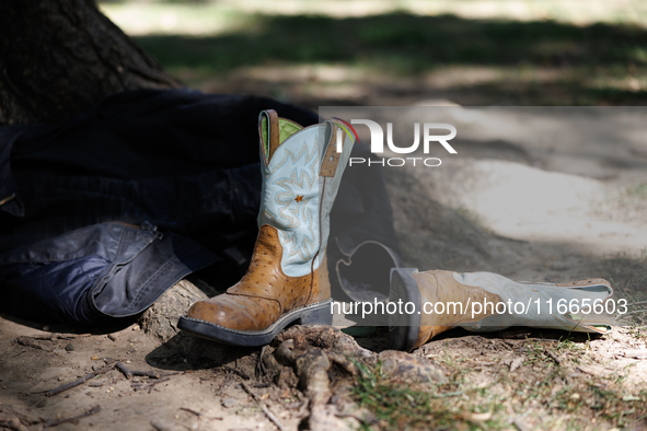 Boots rest against a tree as members of the Muwekma Ohlone Tribe of the San Francisco Bay Area, along with other tribal groups and their sup...