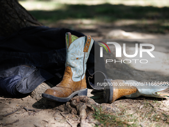 Boots rest against a tree as members of the Muwekma Ohlone Tribe of the San Francisco Bay Area, along with other tribal groups and their sup...