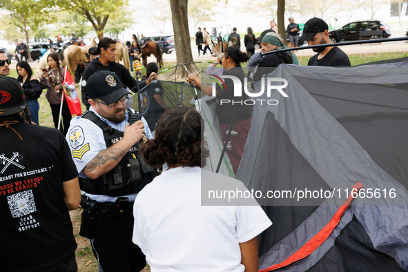 U.S. Park Police officers intervene as members of the Muwekma Ohlone Tribe of the San Francisco Bay Area, along with other tribal groups and...