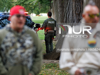 A U.S. Park Police officer enters his vehicle as members of the Muwekma Ohlone Tribe of the San Francisco Bay Area, along with other tribal...