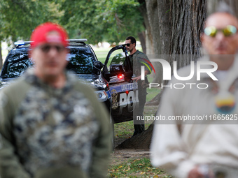 A U.S. Park Police officer enters his vehicle as members of the Muwekma Ohlone Tribe of the San Francisco Bay Area, along with other tribal...