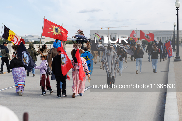 Members of the Muwekma Ohlone Tribe of the San Francisco Bay Area, along with other tribal groups and their supporters, cross the Arlington...