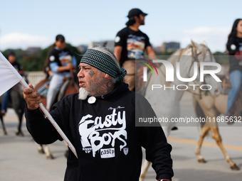 Members of the Muwekma Ohlone Tribe of the San Francisco Bay Area, along with other tribal groups and their supporters, cross the Arlington...