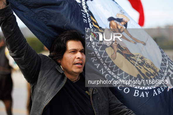 Members of the Muwekma Ohlone Tribe of the San Francisco Bay Area, along with other tribal groups and their supporters, cross the Arlington...