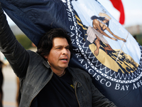 Members of the Muwekma Ohlone Tribe of the San Francisco Bay Area, along with other tribal groups and their supporters, cross the Arlington...