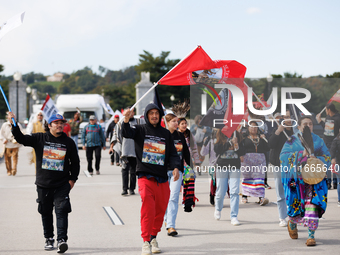 Members of the Muwekma Ohlone Tribe of the San Francisco Bay Area, along with other tribal groups and their supporters, cross the Arlington...