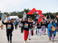 Members of the Muwekma Ohlone Tribe of the San Francisco Bay Area, along with other tribal groups and their supporters, cross the Arlington...