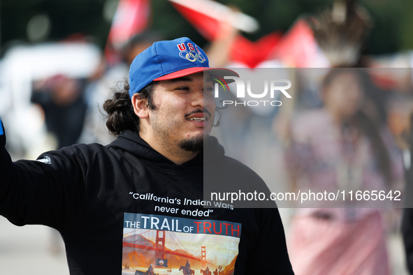 Members of the Muwekma Ohlone Tribe of the San Francisco Bay Area, along with other tribal groups and their supporters, cross the Arlington...