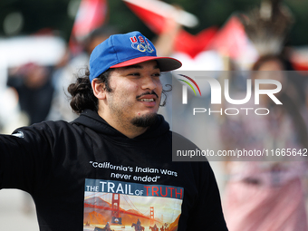 Members of the Muwekma Ohlone Tribe of the San Francisco Bay Area, along with other tribal groups and their supporters, cross the Arlington...