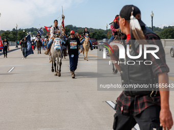 Members of the Muwekma Ohlone Tribe of the San Francisco Bay Area, along with other tribal groups and their supporters, cross the Arlington...