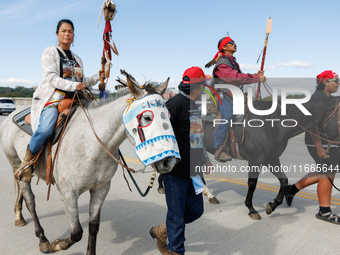 Members of the Muwekma Ohlone Tribe of the San Francisco Bay Area, along with other tribal groups and their supporters, cross the Arlington...