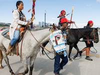 Members of the Muwekma Ohlone Tribe of the San Francisco Bay Area, along with other tribal groups and their supporters, cross the Arlington...