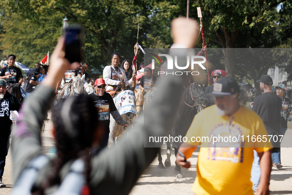 Members of the Muwekma Ohlone Tribe of the San Francisco Bay Area, along with other tribal groups and their supporters, march along the Nati...