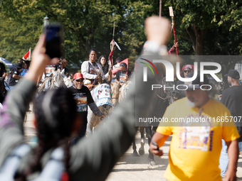 Members of the Muwekma Ohlone Tribe of the San Francisco Bay Area, along with other tribal groups and their supporters, march along the Nati...