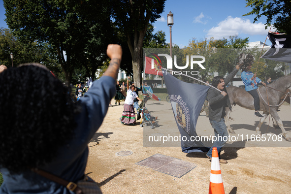 Members of the Muwekma Ohlone Tribe of the San Francisco Bay Area, along with other tribal groups and their supporters, march along the Nati...