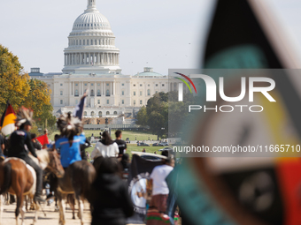 Members of the Muwekma Ohlone Tribe of the San Francisco Bay Area, along with other tribal groups and their supporters, march along the Nati...