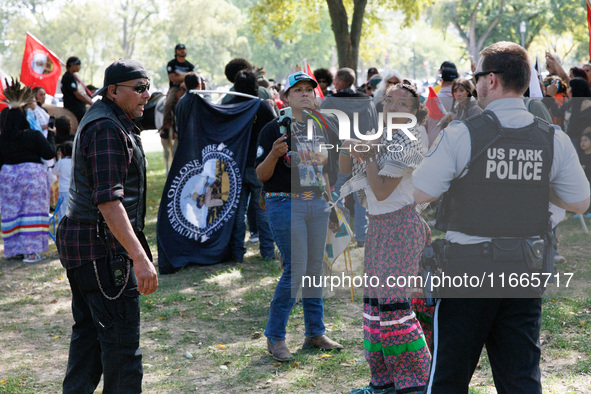 U.S. Park Police officers speak with members of the Muwekma Ohlone Tribe of the San Francisco Bay Area, after the group arrived on horseback...