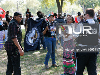 U.S. Park Police officers speak with members of the Muwekma Ohlone Tribe of the San Francisco Bay Area, after the group arrived on horseback...