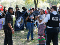 U.S. Park Police officers speak with members of the Muwekma Ohlone Tribe of the San Francisco Bay Area, after the group arrived on horseback...