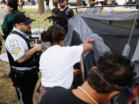 U.S. Park Police officers intervene as members of the Muwekma Ohlone Tribe of the San Francisco Bay Area, along with other tribal groups and...