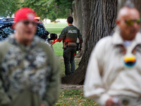 A U.S. Park Police officer enters his vehicle as members of the Muwekma Ohlone Tribe of the San Francisco Bay Area, along with other tribal...