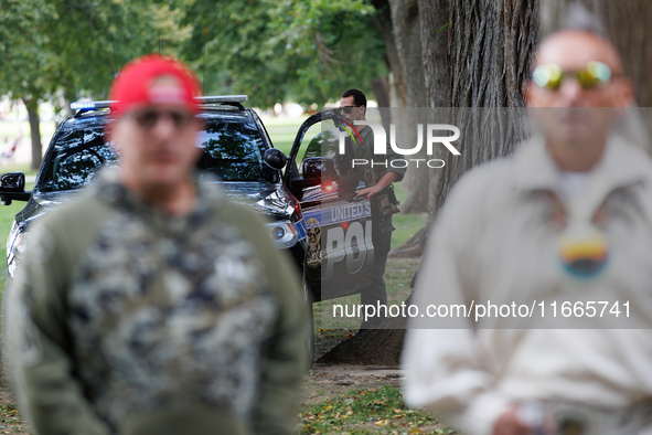 A U.S. Park Police officer enters his vehicle as members of the Muwekma Ohlone Tribe of the San Francisco Bay Area, along with other tribal...