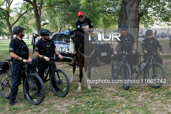 U.S. Capitol Police officers speak with members of the Muwekma Ohlone Tribe of the San Francisco Bay Area, after the group arrived on horseb...