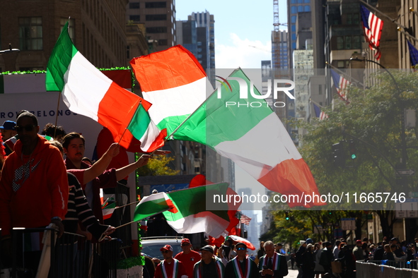 Participants wave flags as they march up 5th Avenue in the Columbus Day Parade in New York City, United States, on October 14, 2024. 