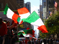 Participants wave flags as they march up 5th Avenue in the Columbus Day Parade in New York City, United States, on October 14, 2024. (